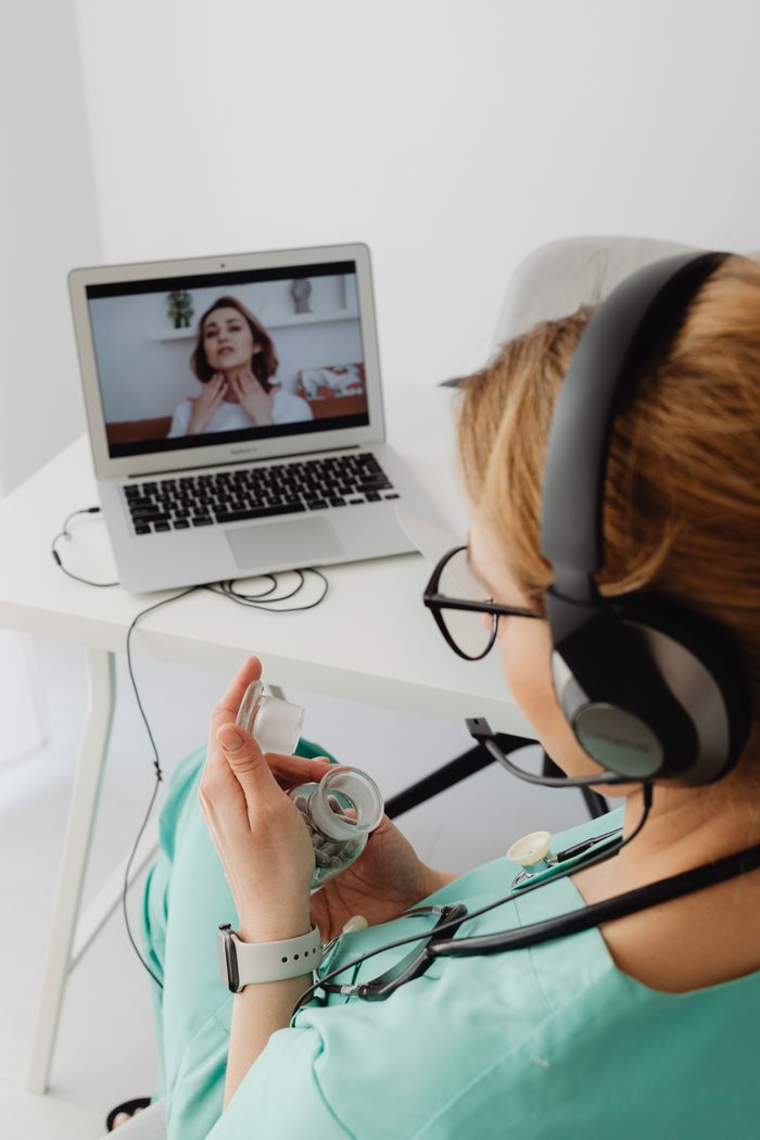 Doctor conducts an online consultation with a patient over a video call.